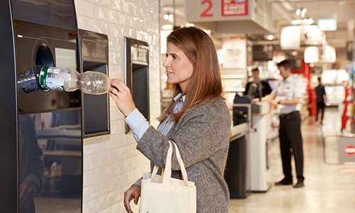 Woman at TOMRA Reverse Vending Machine