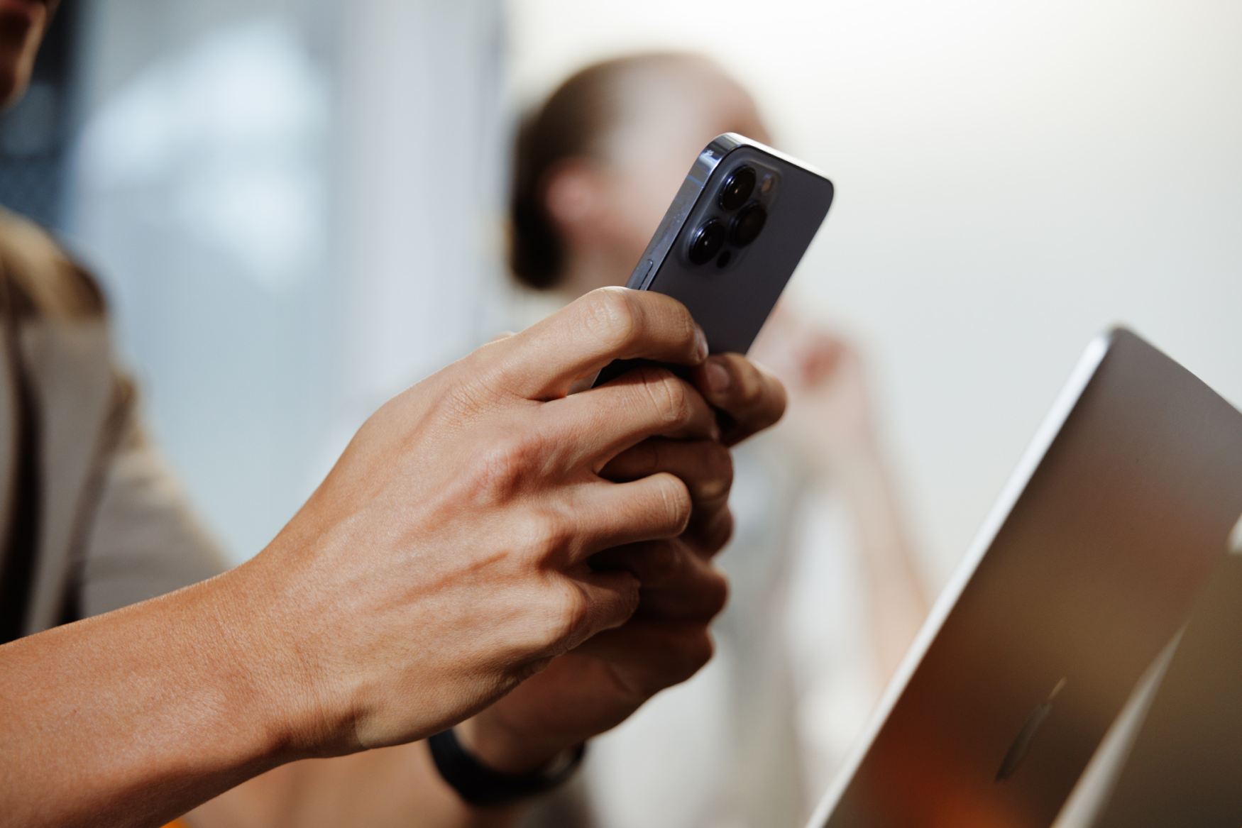 Man's hands typing on phone