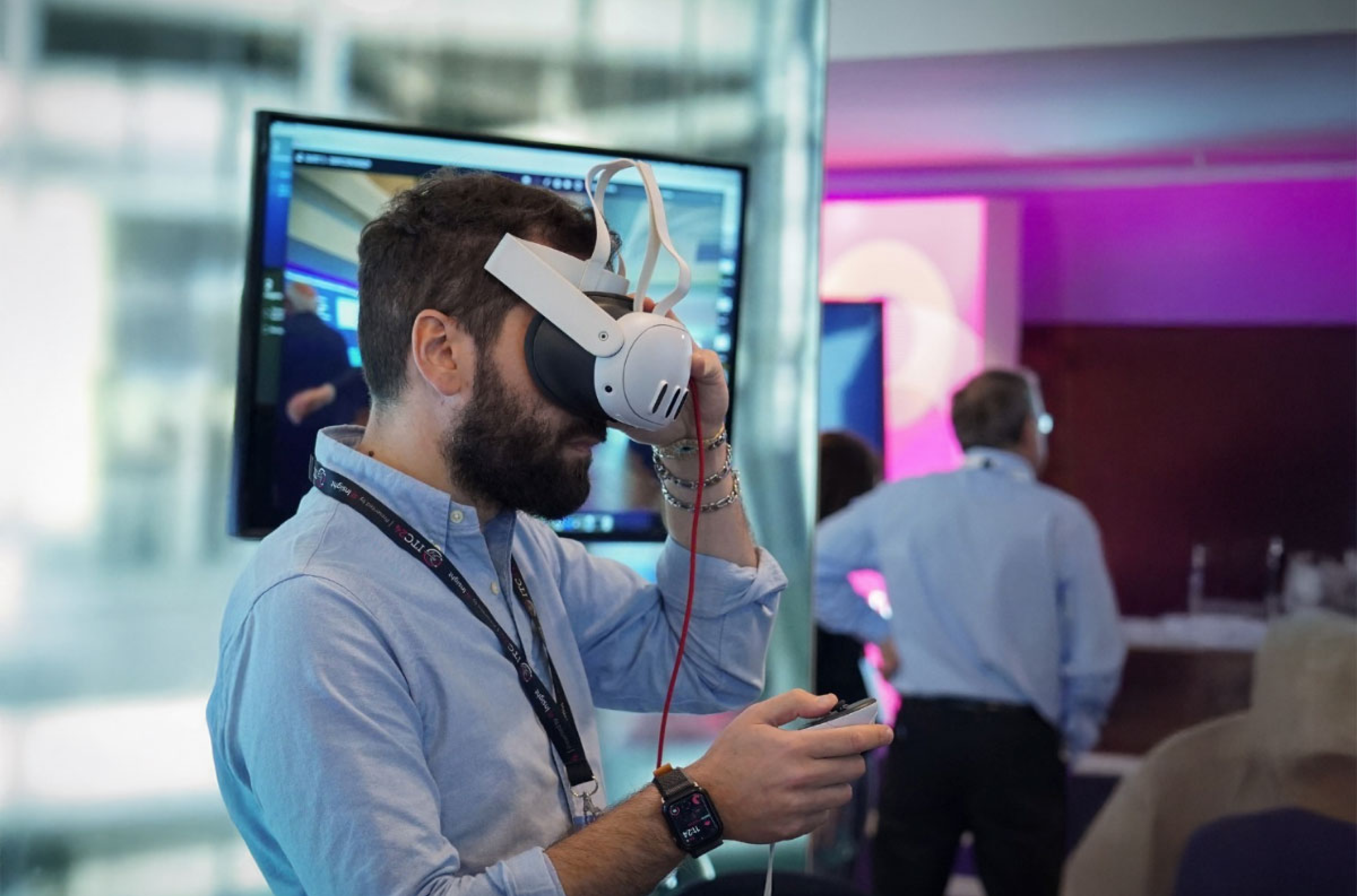 Attendee testing virtual reality headset at tech event