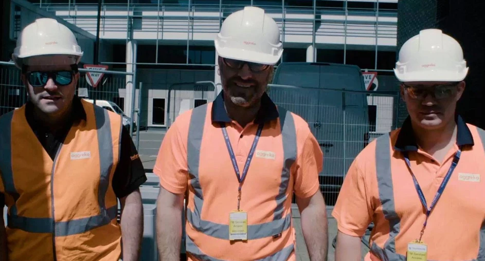 Construction team on active job site in safety gear
