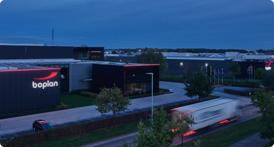 Boplan facility exterior at dusk with active logistics