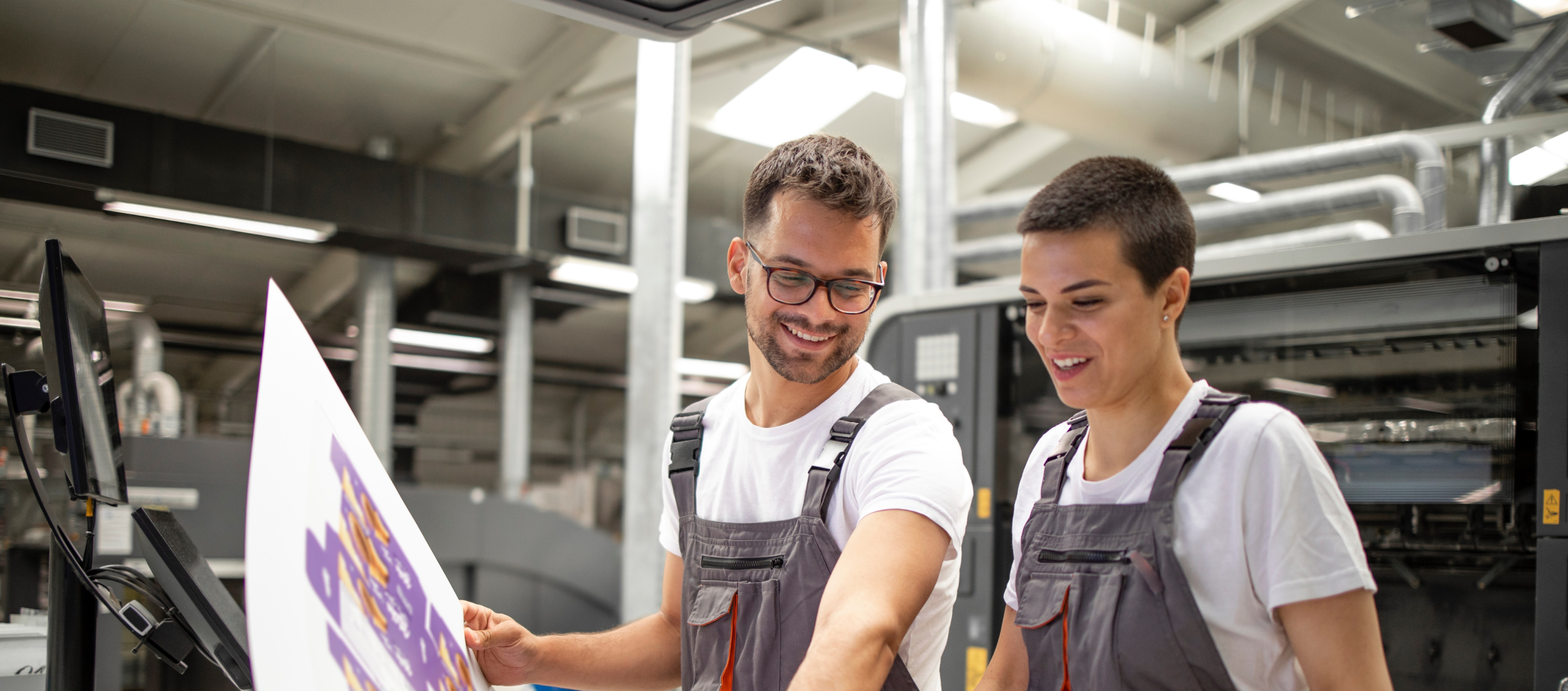Printing technicians reviewing printed material in production facility