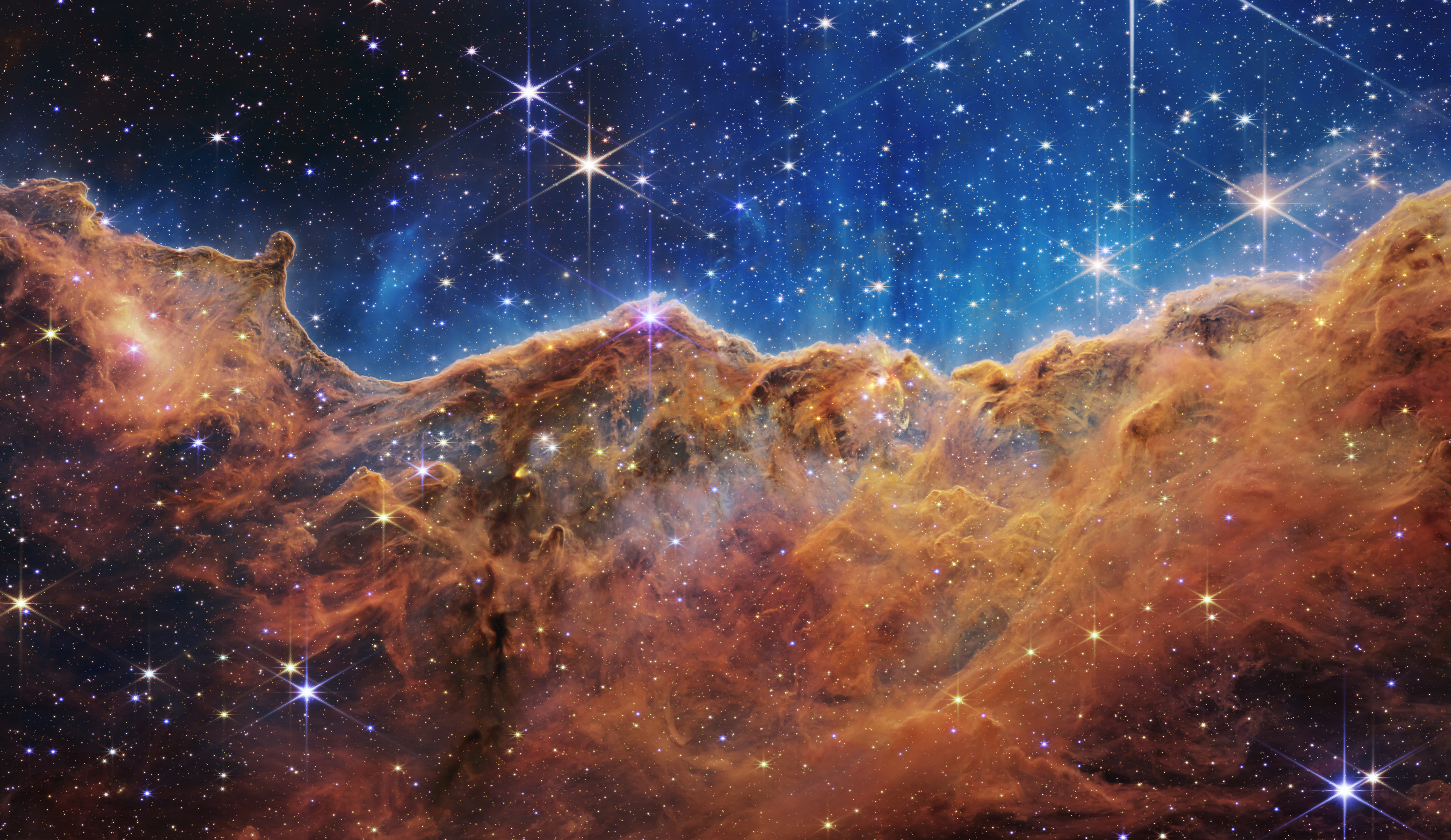 Colorful nebula with glowing gas clouds and stars in deep space