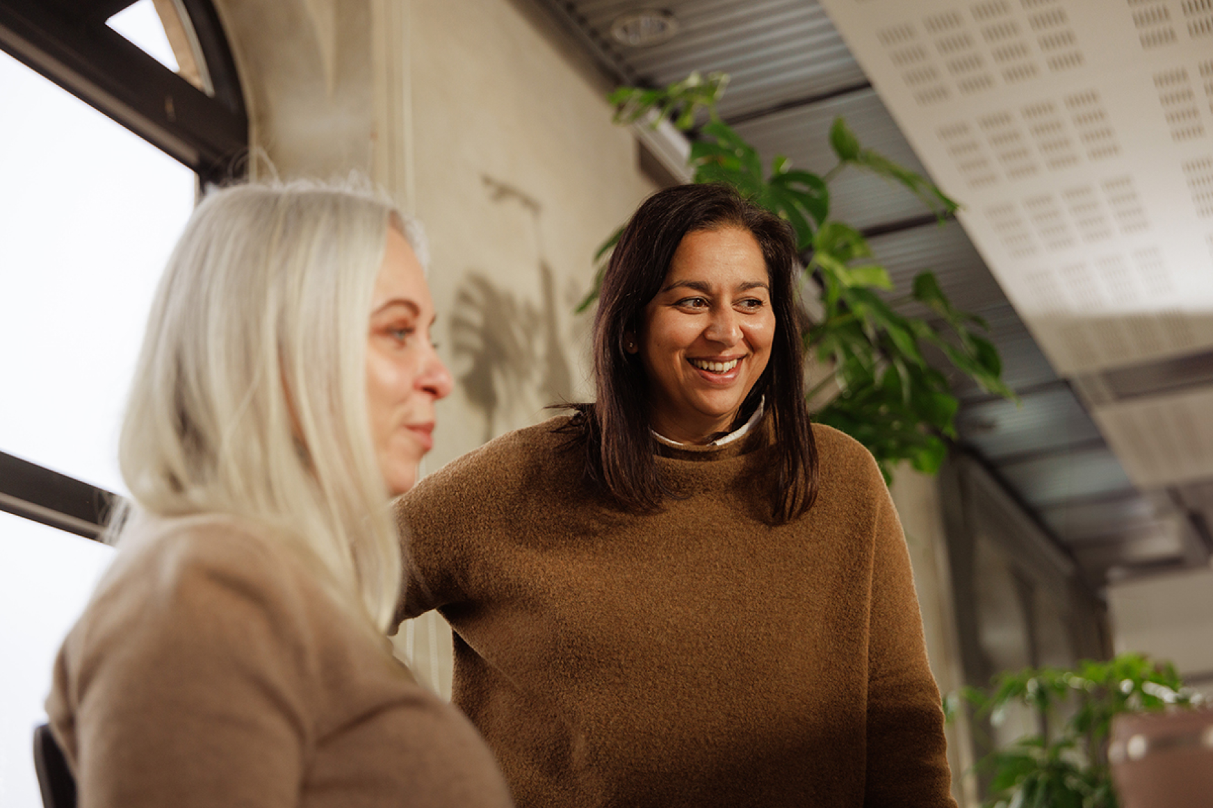 Two women talking at a desk