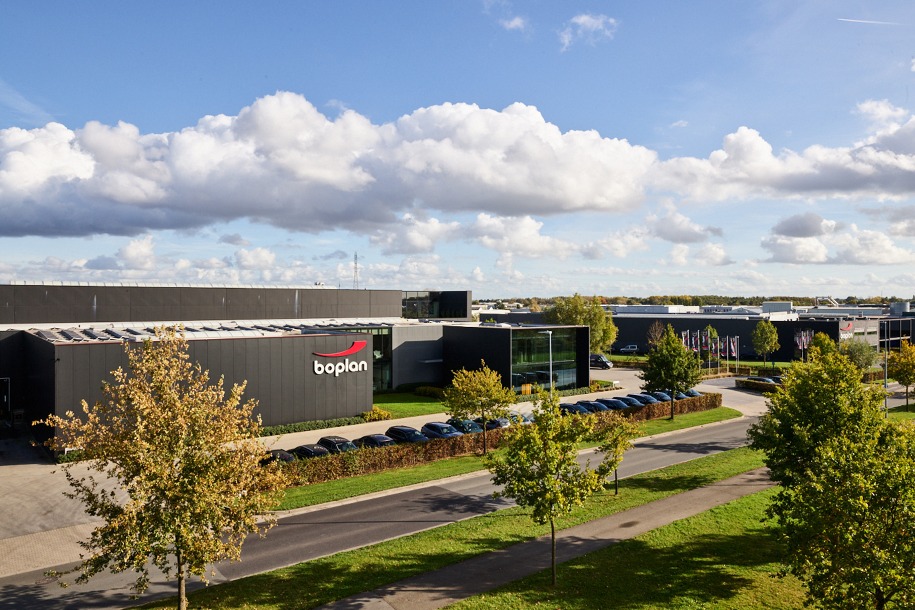 Picture of grey building with BoPlan logo surrounded by trees